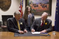 Sen. Stedman signs his oath of office with Lt. Governor Treadwell and his daughter Susie